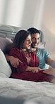 Couple, laughing and watching movie in bedroom with love for comedy, connection or bonding together. Married people, relax and joke in home with smile for funny show, comic video or streaming series.