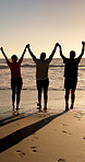 Senior friends, holding hands and celebration at beach, sunset and fitness with space at sea. Elderly people, group and support with back, ocean or outdoor in summer with training in retirement