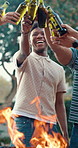 Friends, men and cheers with beer at barbecue, celebration event or new year party outdoor. BBQ, drinks and toast with group of happy people at reunion, social gathering and excited together by fire