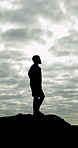 Athlete, man and silhouette for hiking on mountain for fitness, travel adventure and fresh air. Thinking, male person and space for trekking journey, summit challenge and clouds to explore nature