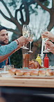 Group, people and cheers with champagne outdoor for lunch, celebration and thanksgiving. Smile, friends and toast alcohol with food for reunion event, social gathering and bonding together at house

