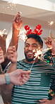 Happy people, friends or celebration with sparklers for festive party, social gathering or new year. Excited, group or community with smile or fireworks for christmas, December holiday or bonding