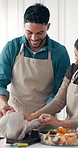 Thanksgiving, couple and cooking turkey for meal prep, bonding or adding flavor to food in kitchen. Happy man, woman or stuffing poultry in home for hosting dinner, talking and festive dish with help