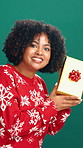 Christmas, gift and face of woman in studio with guess for holiday, tradition and festive season. Happy, December and portrait of person with present for celebration, xmas and box on green background