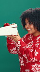 Christmas, open gift and face of woman in studio for holiday, surprise and festive season sale. Happy, December and portrait of person with box for celebration, xmas and present on green background