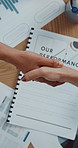 Above, shaking hands and business people in office with documents, agreement and company audit. Group, handshake or employees in workplace with graphs, partnership and charts for performance deal