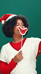 Woman, selfie and excited at Christmas in studio with lips sticker, happy or post on green background. Person, smile and photography with santa hat, emoji and profile picture for social media at xmas