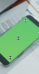 Phone, green screen and documents at empty office, admin and mockup space for advertising at finance agency. Smartphone, display ui and paperwork for asset management, contract and marketing on desk