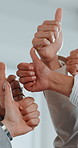 Thumbs up, collaboration and hands of business people in office with agreement, teamwork or deal. Partnership, community and corporate employees with approval gesture for solidarity in workplace.