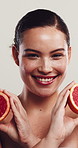 Face, grapefruit and woman in studio for skincare, natural wellness or laugh. Portrait, citrus or happy model with organic cosmetic for beauty, vitamin c or funny with antioxidant on white background