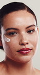 Face, woman and cream for skincare with glow, natural dermatology and sunscreen product. Acne lotion, cosmetics and model with moisturizer for hydration, beauty portrait or white background in studio