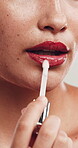 Makeup, woman and lip gloss application in studio, beauty aesthetic and mouth color for shine finish. Cosmetology, self care and person with facial product for hydration glow, wellness and closeup.