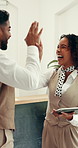 Smile, people and high five with tablet at hotel for success, online booking and positive feedback. Excited, team and digital for good news, recognition and celebration for hospitality achievement