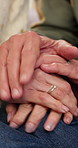 Comfort, holding hands and support with senior couple in home together for love or wellness. Empathy, help and trust with old people on sofa in living room of apartment for peace or retirement