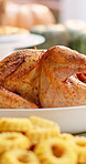 Thanksgiving, tradition and turkey on table in dining room for festive holiday, feast decoration and meal. Culture, season and roast dinner with chicken and spread in home for event, dishes and food