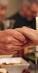 Holding hands, praying and family in home at dinner with religion, bonding or reunion together. Faith, meal and people with prayer for worship in dining room with gratitude for food in house.