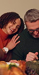 Thanksgiving dinner, funny and happy couple in home, bonding together and celebration. Dining room, mature man and woman with love, interracial partner and laugh at joke with food for holiday feast