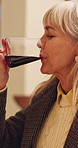 Break, night and wine with senior woman in dining room of home for beverage, event or holiday. Alcohol, drink and glass with old person in apartment to relax for retirement or weekend wellness