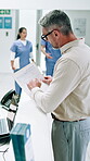 Man, front desk and documents for hospital form, help and question with pen for personal info in healthcare. Mature person, appointment and advice at reception, health insurance or consent paperwork