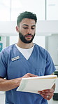 Healthcare, man and nurse in hospital, documents and report for illness, reading and wellness. Uniform, medical service and person in lobby, clinical trial and paperwork for schedule and information