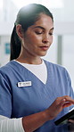Tablet, woman and nurse in hospital with research for medical diagnosis or treatment plan. Digital technology, professional and female healthcare worker with online insurance report in clinic.