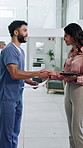 Happy, woman and handshake with nurse, clinic and reading patient diagnosis or explain with document. Hospital, people and shaking hands for teamwork, tablet and medical professional with paperwork