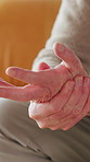 Hands, inflammation and wrist pain with senior person closeup in retirement home for condition or injury. Arthritis, fibromyalgia and lupus with elderly man in apartment for circulation or tension