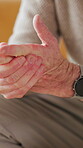 Arthritis, hands and inflammation with senior person closeup in retirement home for condition or injury. Fibromyalgia, lupus and pain with elderly man in apartment for circulation or tension