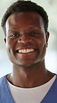 Face, black man and doctor in hospital with smile for healthcare career, opportunity and internship. Happy, person or male nurse in clinic with pride for medical service, patient support or about us.
