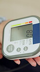 Hands, person and machine to monitor blood pressure for heart health, medical test and hypertension. Above, woman and equipment for healthcare exam, vital signs and increase results of stress in home