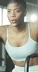 Fitness, cycling and black woman in gym with workout, wellness or training for cardio. Happy, breathing and African female athlete for exercise on stationery bike for health in sports center.