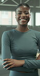 Face, happy and black woman in gym with arms crossed for fitness, healthy body goals and wellness. Confident, female person or smile for mood boost, stress relief or workout challenge in health club.