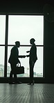 Businessman, woman and handshake by window with welcome, deal or talk for property negotiation. African people, realtor and shaking hands with investor, hello and discussion for real estate sale