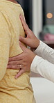 Back pain, massage and physical therapy in clinic, hands and helping with muscle tension and injury. Physiotherapist, rehabilitation and senior person with stiffness, recovery and healing spine