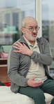 Conversation, shoulder pain and therapy with old man in clinic for assessment or rehabilitation. Discussion, explain and injury with senior patient in physiotherapy session for recovery or treatment