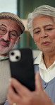 Home, video call and senior couple with cellphone, hello and wave with communication, app and talking. Pensioners, apartment and mature man with woman, smartphone and greeting with online chatting