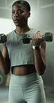 Black woman, fitness or weightlifting with dumbbells for workout, muscle gain or training in gym. Active, female person or lifting with weights for arm exercise, bicep curl or wellness in health club