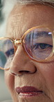 Thinking, sad and senior woman in home with alzheimers, depression or reflection for past. Glasses, grief and elderly female person in retirement with dementia, loneliness and memories in house.