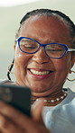 Phone, happy and senior black woman in home with networking, chatting or social media on app. Technology, relax and African elderly female person in retirement with blog on cellphone in living room