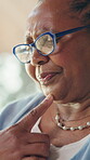 Thinking, senior black woman and glasses at house with memory, reflection and nostalgia in living room. Alzheimers, ideas and elderly female person in retirement with planning for day on sofa in home