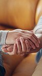 Nurse, senior person and holding hands on sofa with care, connection and comfort in retirement home. People, caregiver and elderly patient with support, console and kindness on couch at apartment