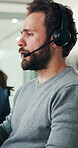 Feedback, headset and support with man in call center for assistance, contact us or virtual help. Communication, conversation and customer service with person in coworking office for consulting