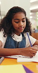 Girl, student or writing with homework in library for pattern, tracing or fine motor skill. Happy child, kid or learner with pencil or paper for education, learning or childhood development in school
