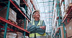 Logistics, woman and happy with arms crossed in warehouse for supply chain, cargo export or pride. Distribution manager, mature person and smile in storage facility for stock management or inspection