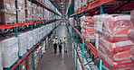 Above, supply chain and people in warehouse, conversation and organize inventory with storage inspection. Industrial, logistics and employees with safety, distribution or talking with cooperation