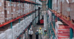 Above, supply chain and people in warehouse, walking and logistics with storage inspection. Inventory, distribution or employees with discussion, export or maintenance with quality control or backlog