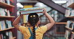 Library, balance books and back of child for learning, education and language development. Walking, bookshelf and girl with literature, story and novel on head for knowledge, research and information