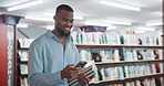 Black man, student and phone with texting at library for research project, books or smile for scholarship. Person, smartphone and happy on mobile app for assessment, chat and education at university