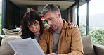 Paper, review or couple in home with list, signing will or trust agreement in marriage. Reading, mature man or woman on sofa with counting, discussion or postnuptial planning on legal document.