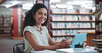 Woman, college student and face with laptop at library, happy and pride with typing for assessment. Girl, portrait and smile with computer, books or confidence for scholarship at university in Brazil